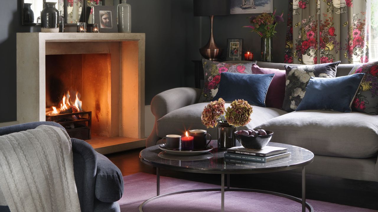 Dark living room with rich colours and open fire