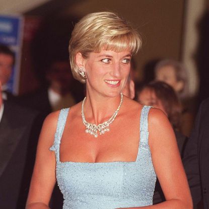 Princess Diana wears a baby blue dress with a diamond necklace