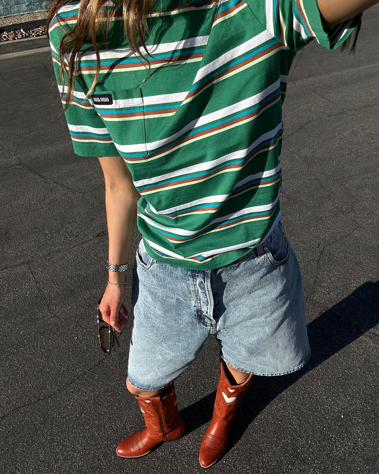Cowboy boots styled with a striped T-shirt