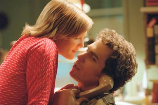 drew barrymore leans over sam rockwell on the phone in the movie confessions of a dangerous mind