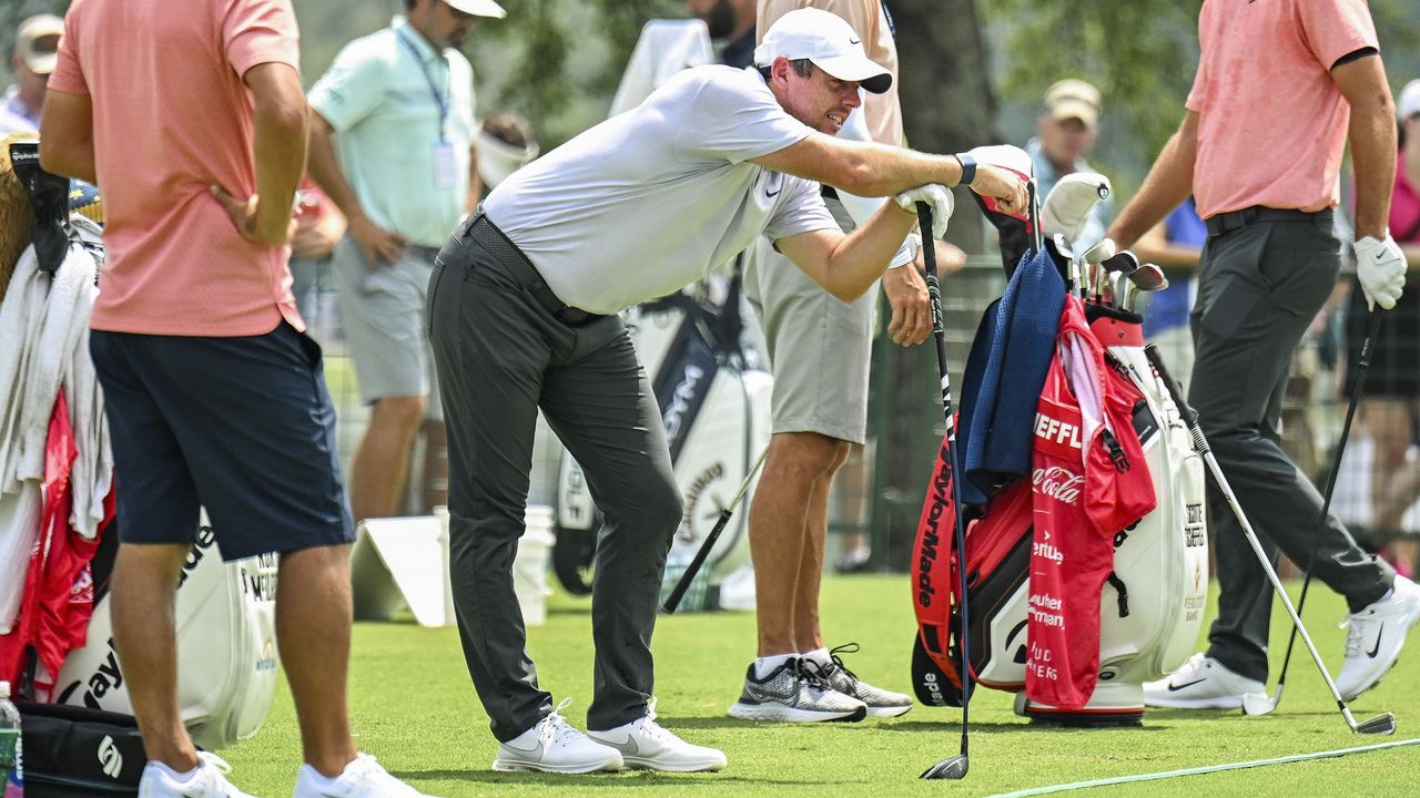 Rory McIlroy stretching out his back injury