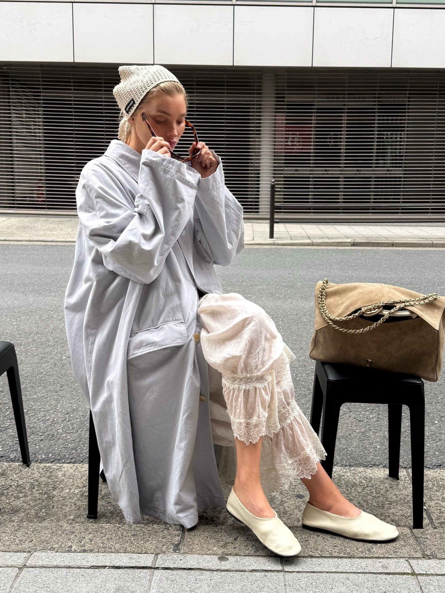 Elsa Hosk wearing petticoat pants with a trench coat and flats in Tokyo