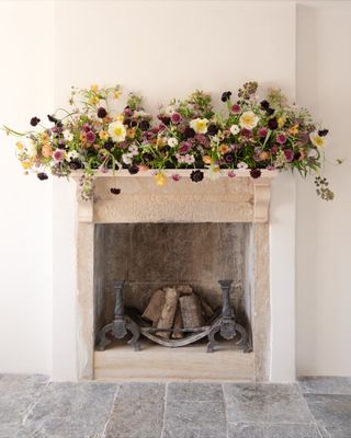 Fresh floral mantelpiece flower arrangement by Philippa Craddock