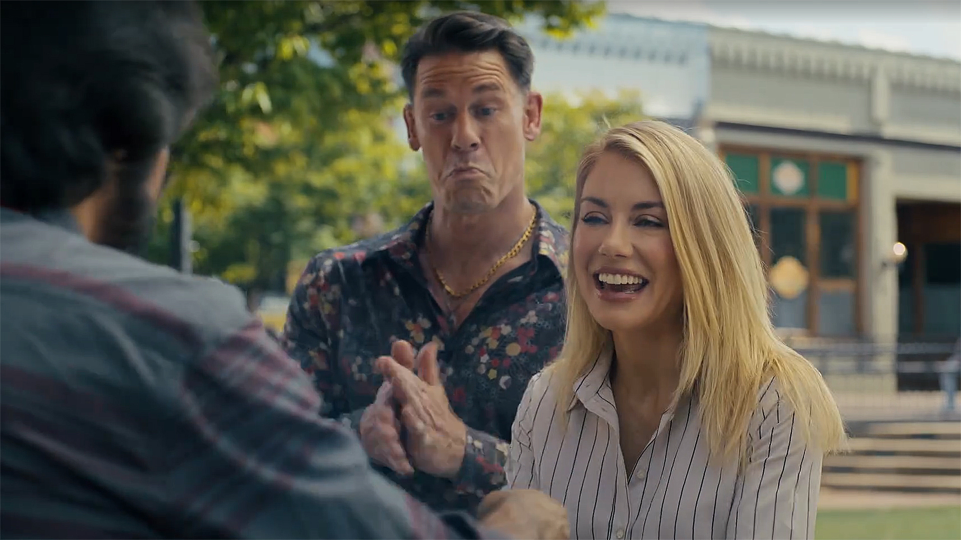 Emilia Harcourt 2 smiling as Chris Smith rubs his hands together in Peacemaker season 2 episode 3