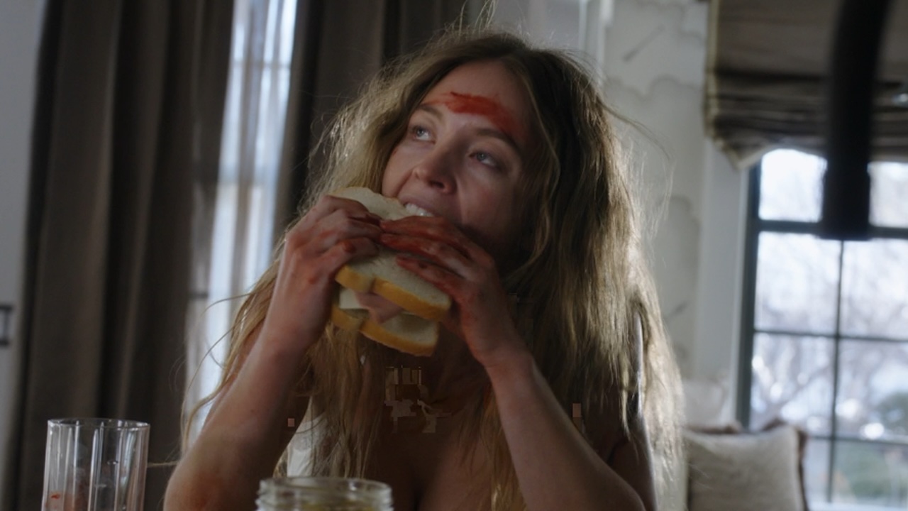 Sydney Sweeney eating a sandwich with blood on her face in The Housemaid
