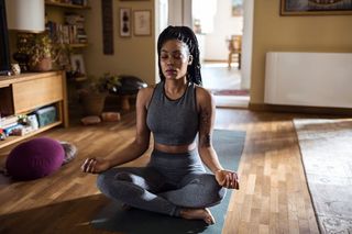 A woman meditating at home