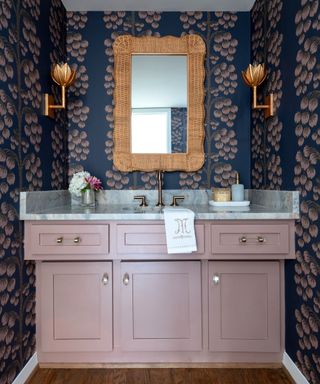 Powder room with navy wallpaper and mauve vanity unit by Gaia G Interiors, photograph Michael Hunter
