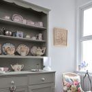 dresser with cushion and grey cabinet