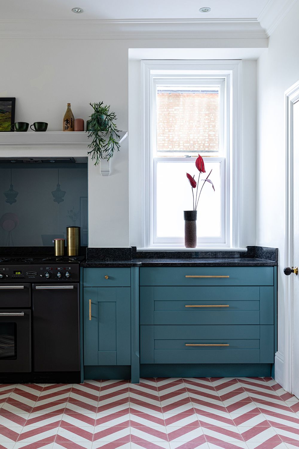 kitchen floor tile ideas with red and white herringbone zig zag vinyl tiles and blue cabinets