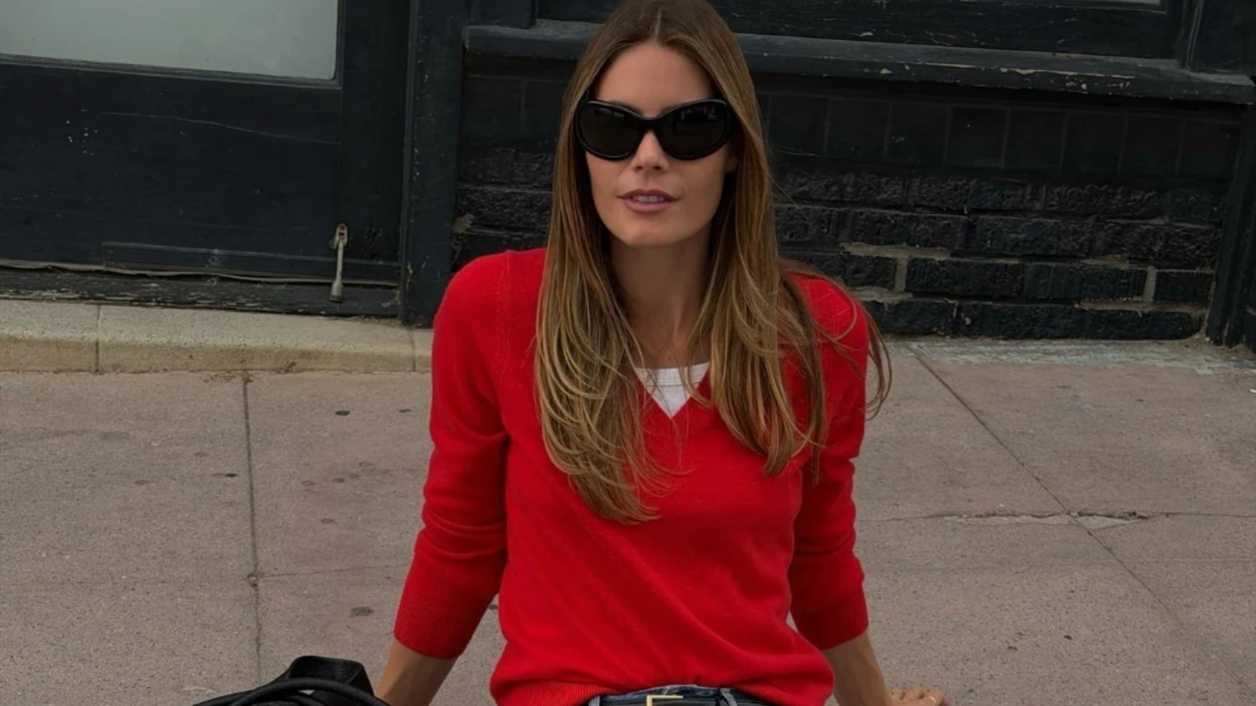 A woman in a red cashmere sweater.