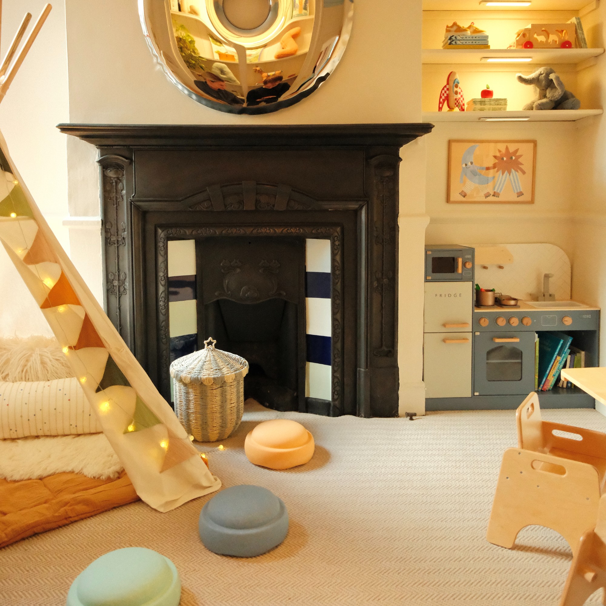 Zac's playroom designed by Tash Bradley with a teepee tent and a blue play kitchen