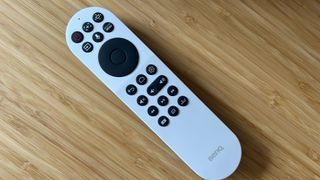 BenQ X300G remote control on a wooden table