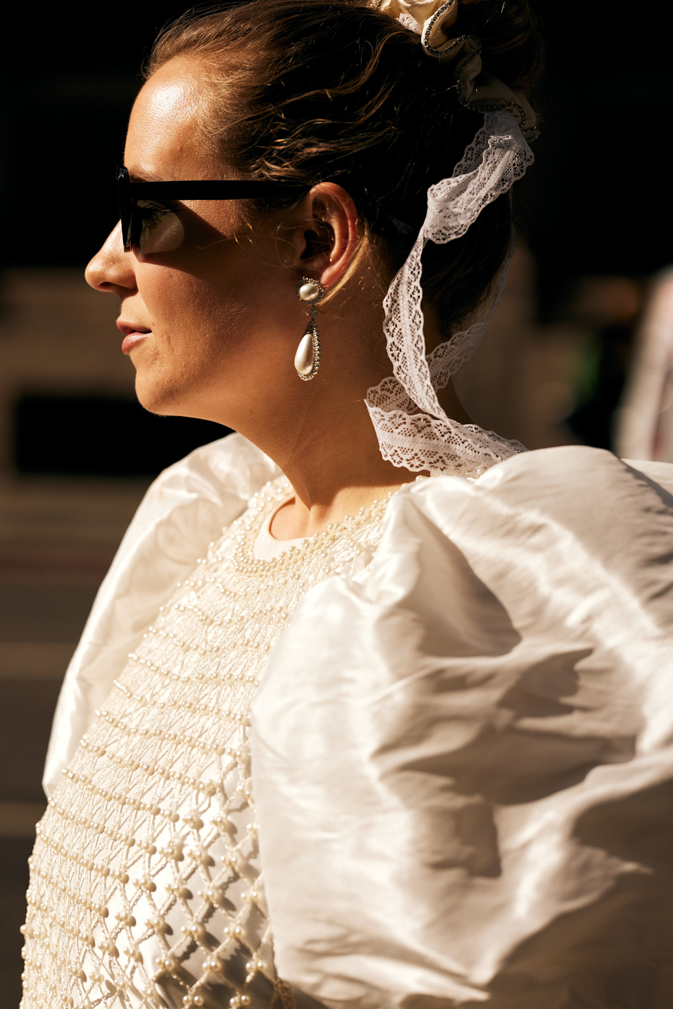 woman with bow attached to hair scrunchie and puffy white blouse