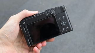 The back of a Panasonic Lumix S9 camera held in a hand