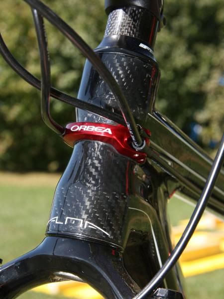 Orbea's Direct Cable routing system starts with this trick head tube badge.