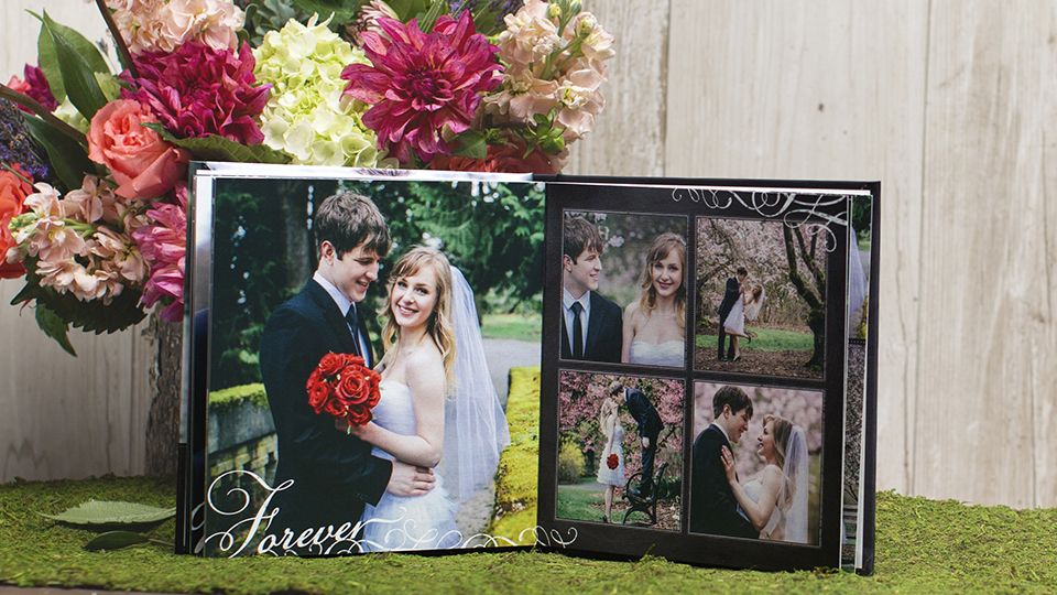 Wedding photo book placed in front of a bouquet of flowers