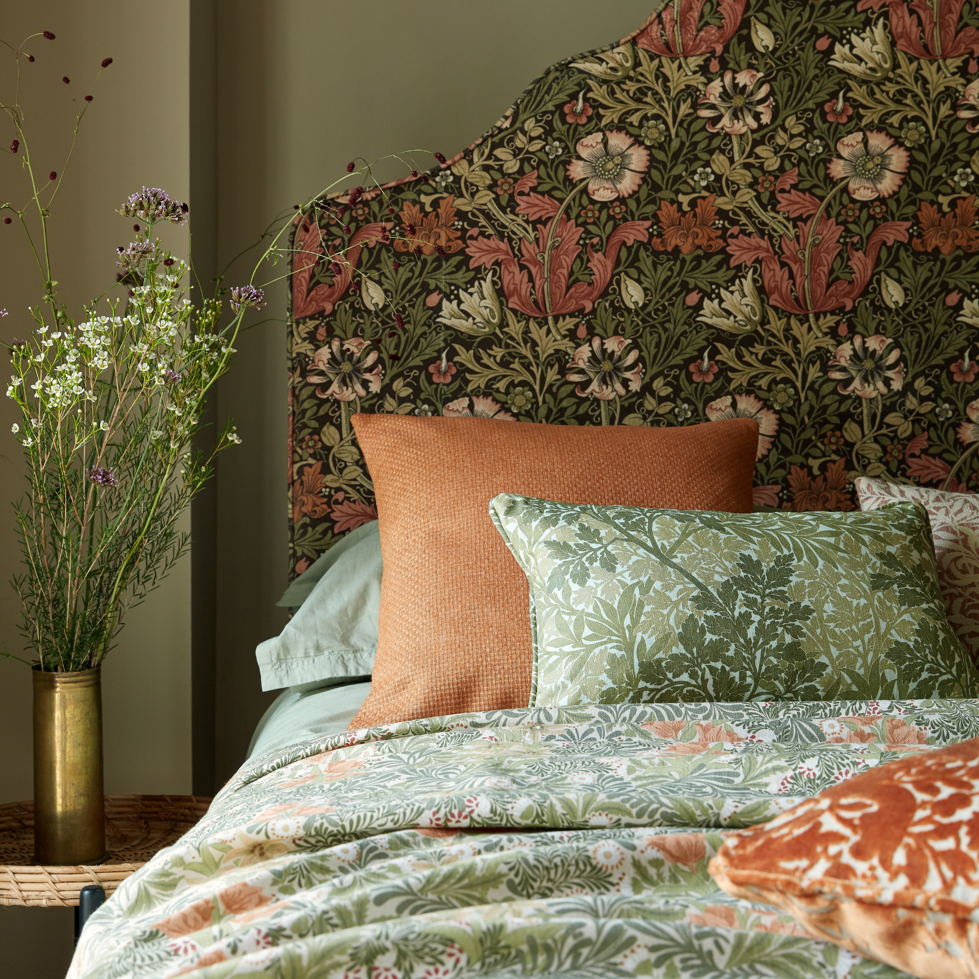 A covered headboard in william morris print fabric