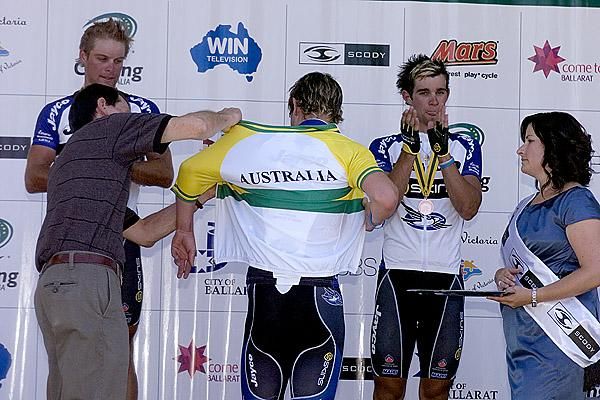 Try this on for size: Michael Hepburn is fitted with his Australian jersey on the podium after winning the men's under 23 road race.
