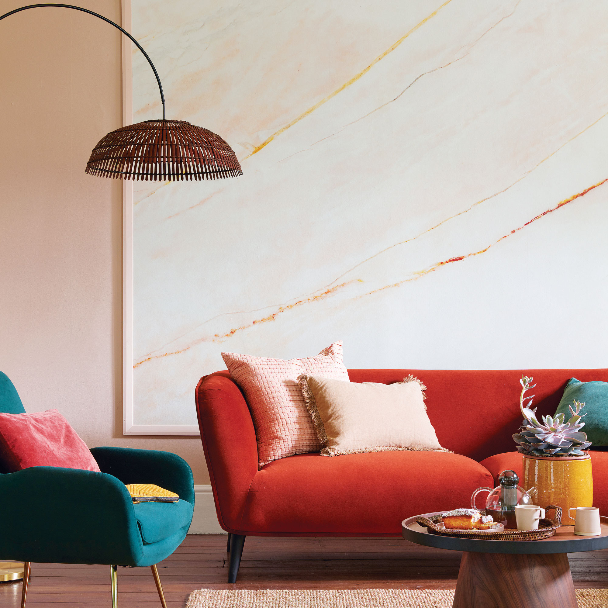 Pink living room with large wall art, and hanging floor lamp