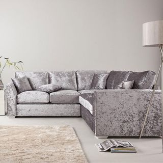 white living room with silver sofa and carpet