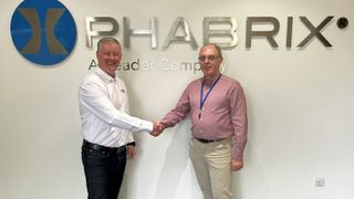 Retiring CEO and founder Phillip Adams shakes hands at PHABRIX. 