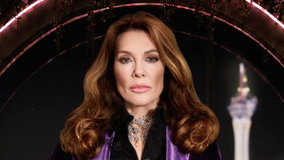 Lisa Vanderpump in black and purple evening dress looking into the camera ahead of her 2-night special Vanderpump Rules: Lisa Las Vegas on Bravo and Peacock