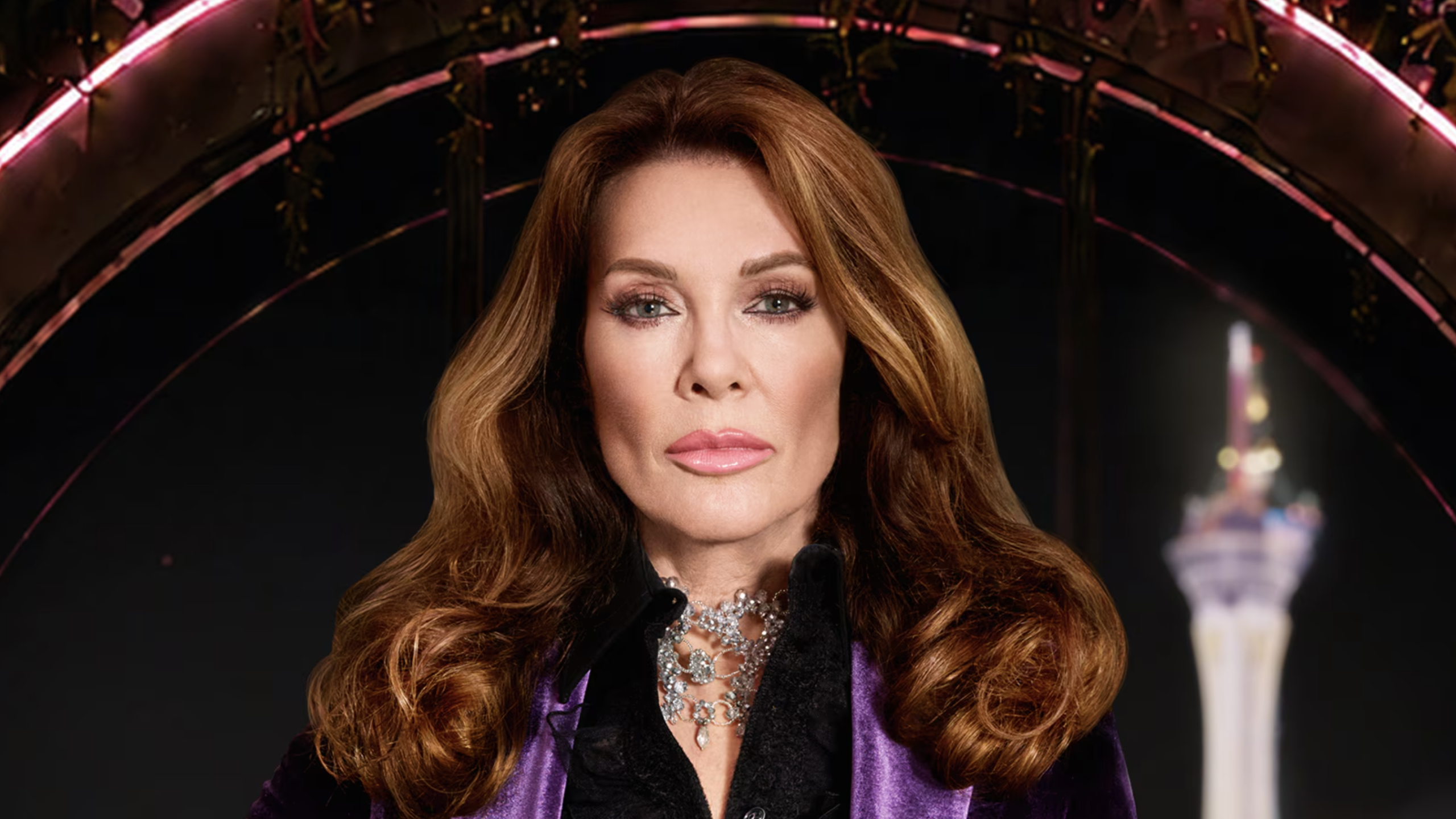 Lisa Vanderpump in black and purple evening dress looking into the camera ahead of her 2-night special Vanderpump Rules: Lisa Las Vegas on Bravo and Peacock