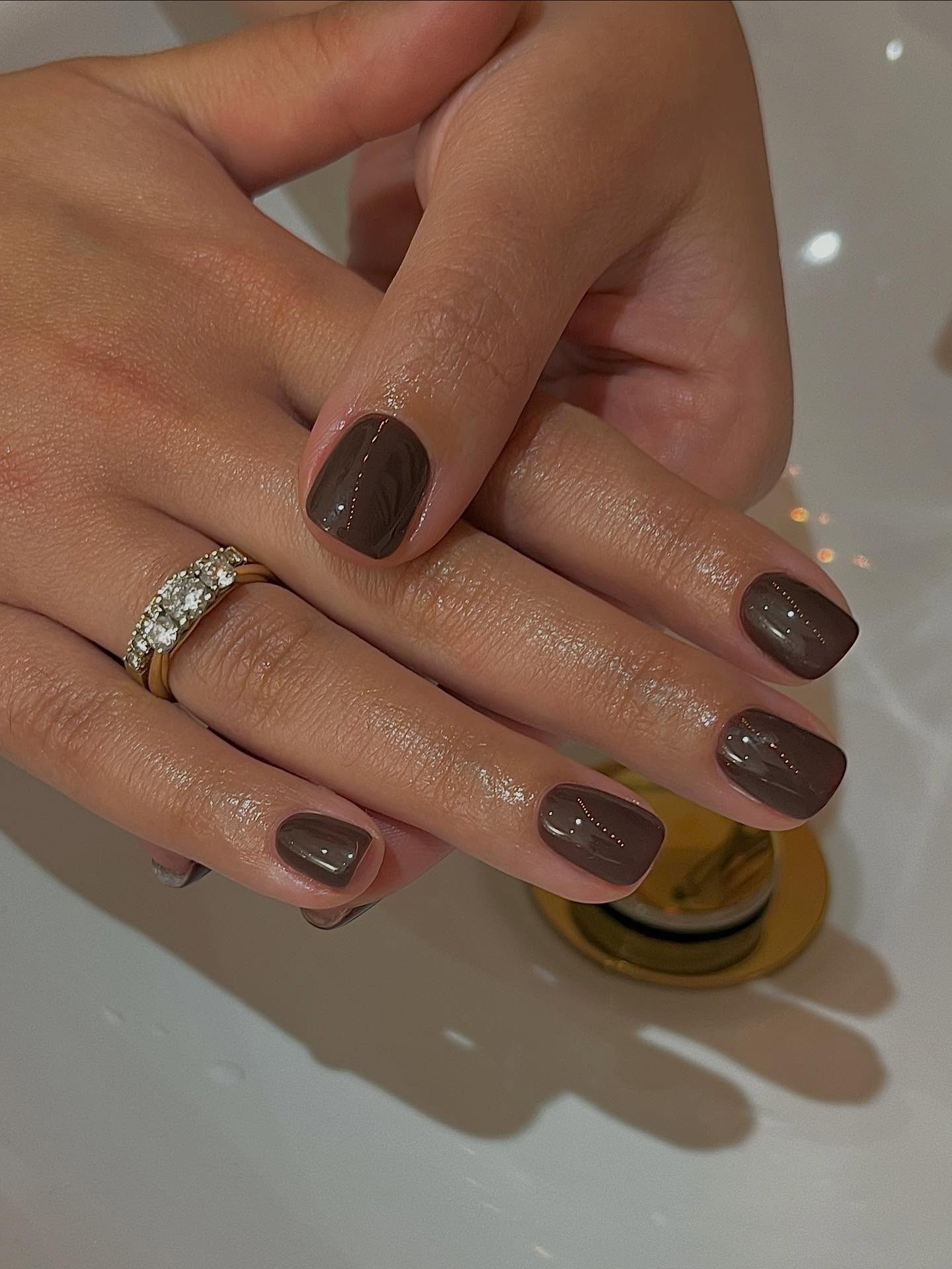 Brown glossy nails.