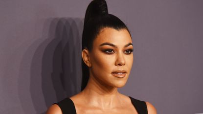 kourtney kardashian on a gray background