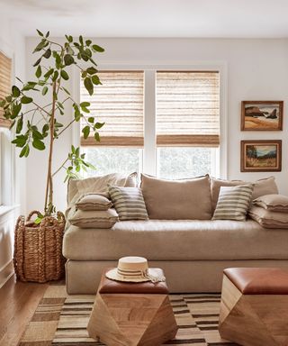 A neutral living room with white walls, wicker and rattan accents and pale, earthy tones.