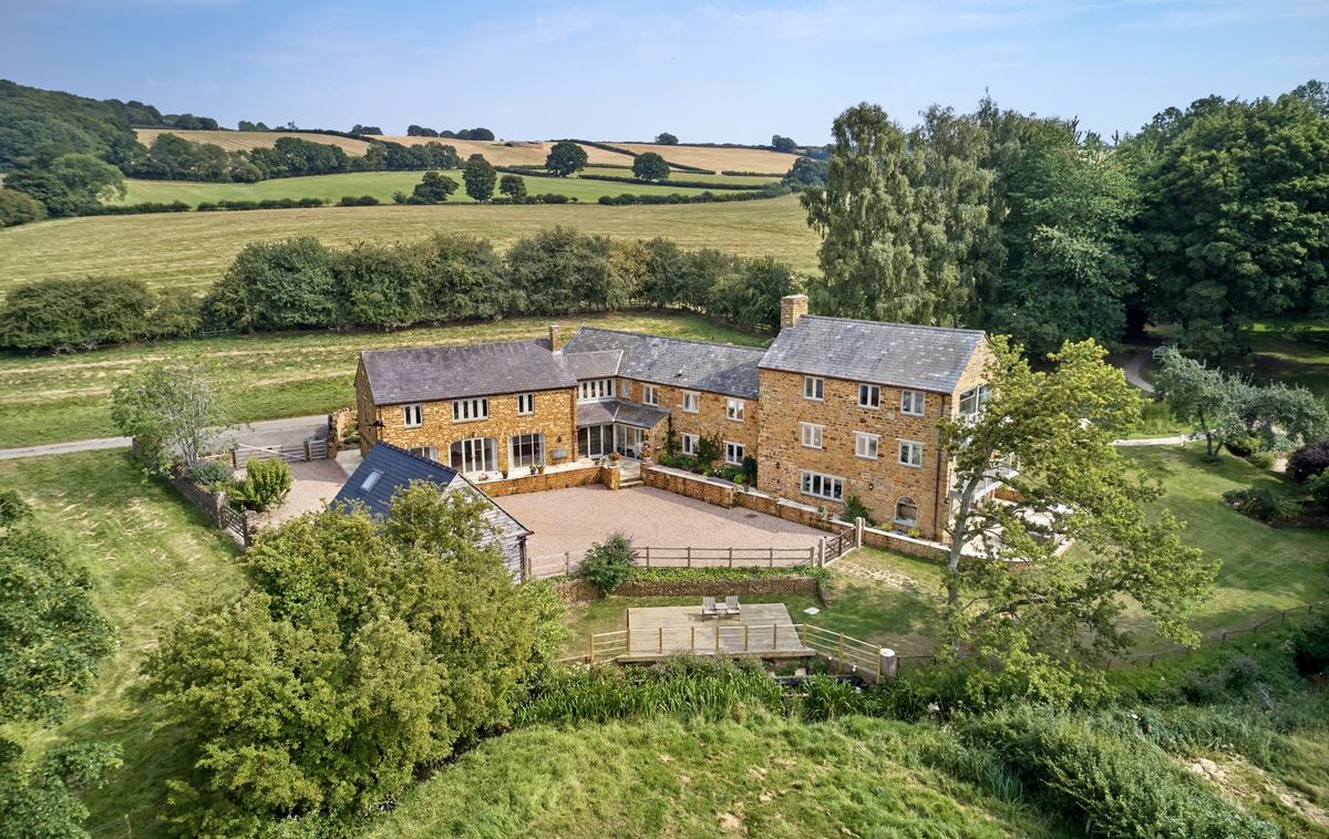 View of the back of the converted mill showing the back garden and the back of the L shaped house