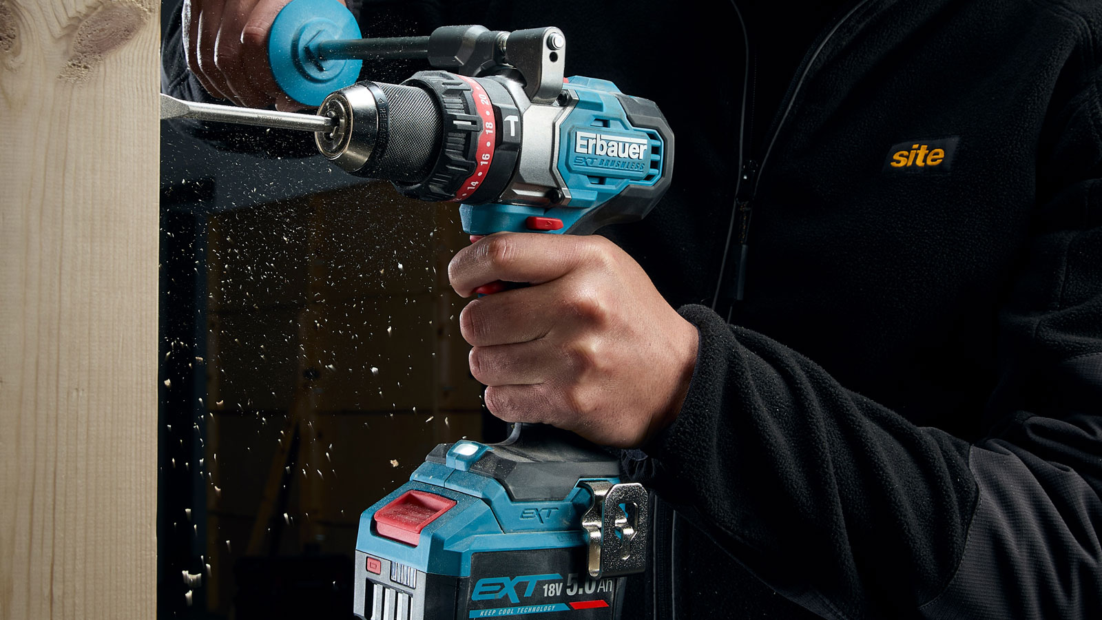 Person holding Erbauer EXT 18V Elite Combi Drill drilling into wood