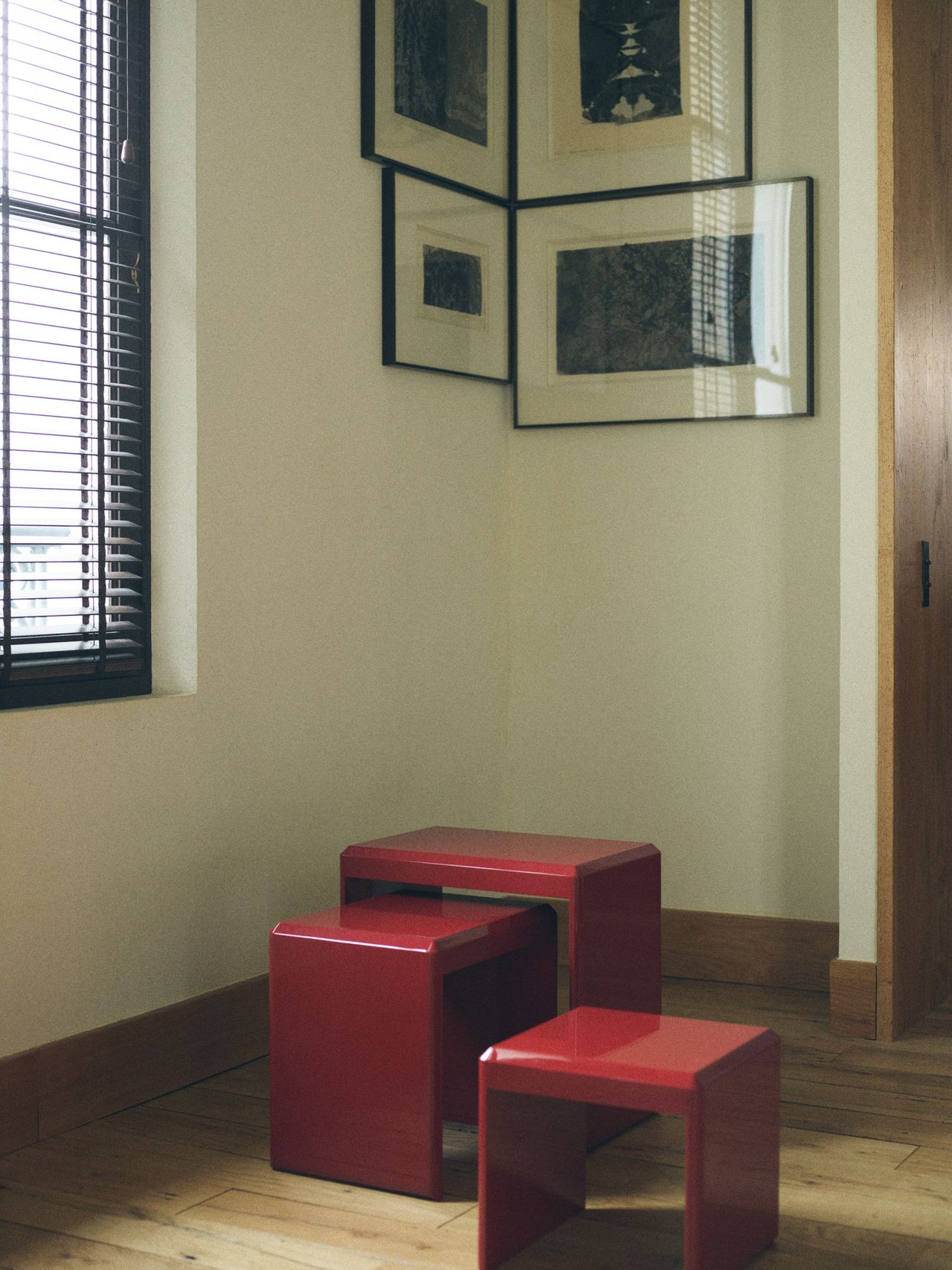 A series of products from Zara Home designed by NYC's Colin King, including red lacquered nesting tables, a red vessel, an egg-shaped lamp, and a basked woven in brass.