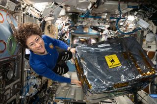 NASA astronaut and Expedition 61 Flight Engineer Christina Koch handles science hardware stowed inside a cargo transfer bag on board the International Space Station in December 2019. Koch is setting a new record for the longest mission by a woman.