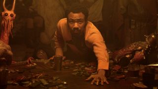 Donald Glover looks up from the betting table in Solo: A Star Wars Story.