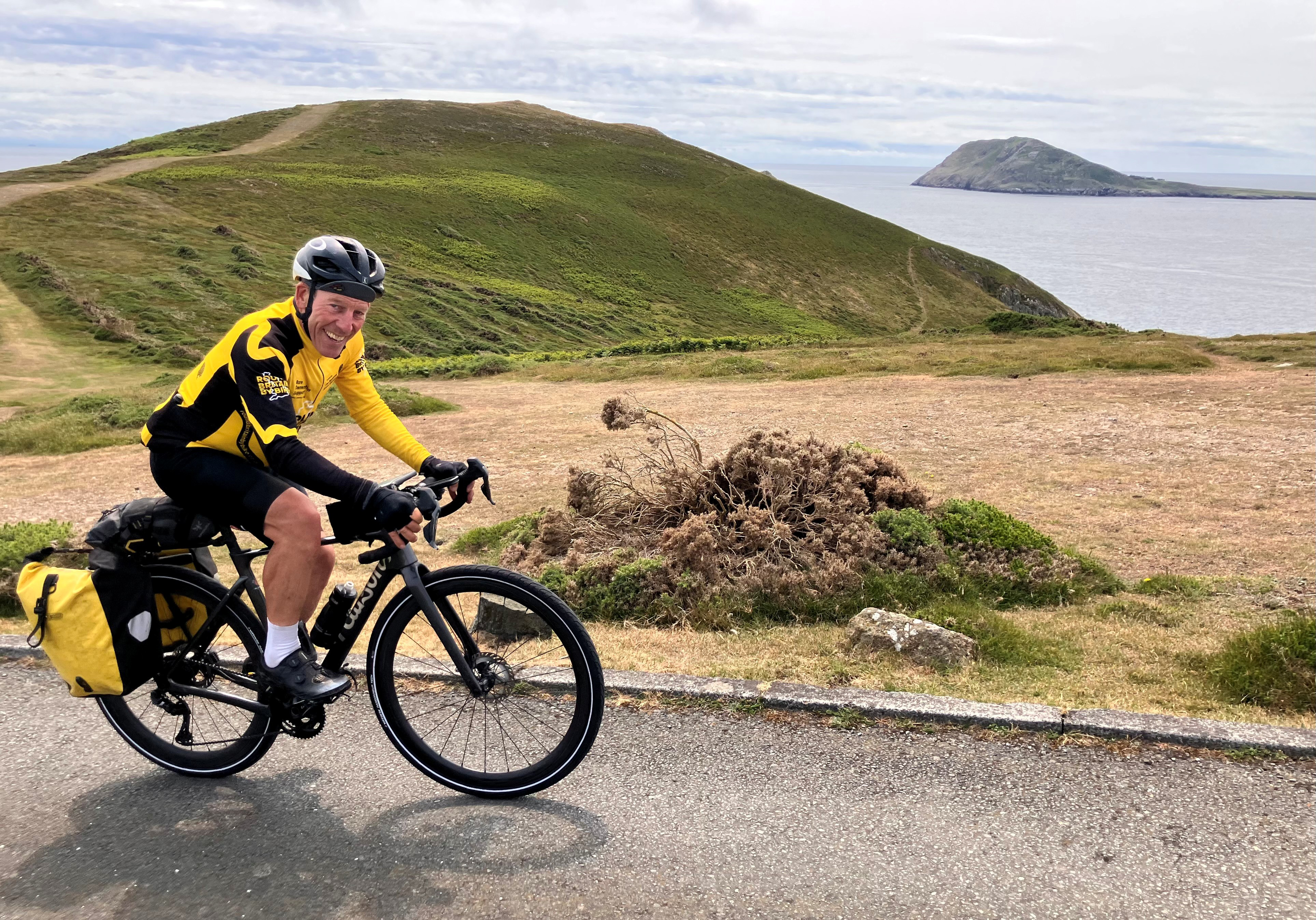 Man cycles next to the coast