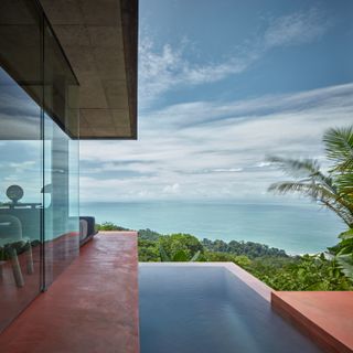 Pool beside Costa Rican retreat set above the forest and looking out to sea