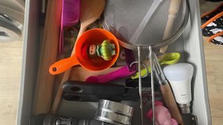 Cluttered kitchen drawers that need tidying