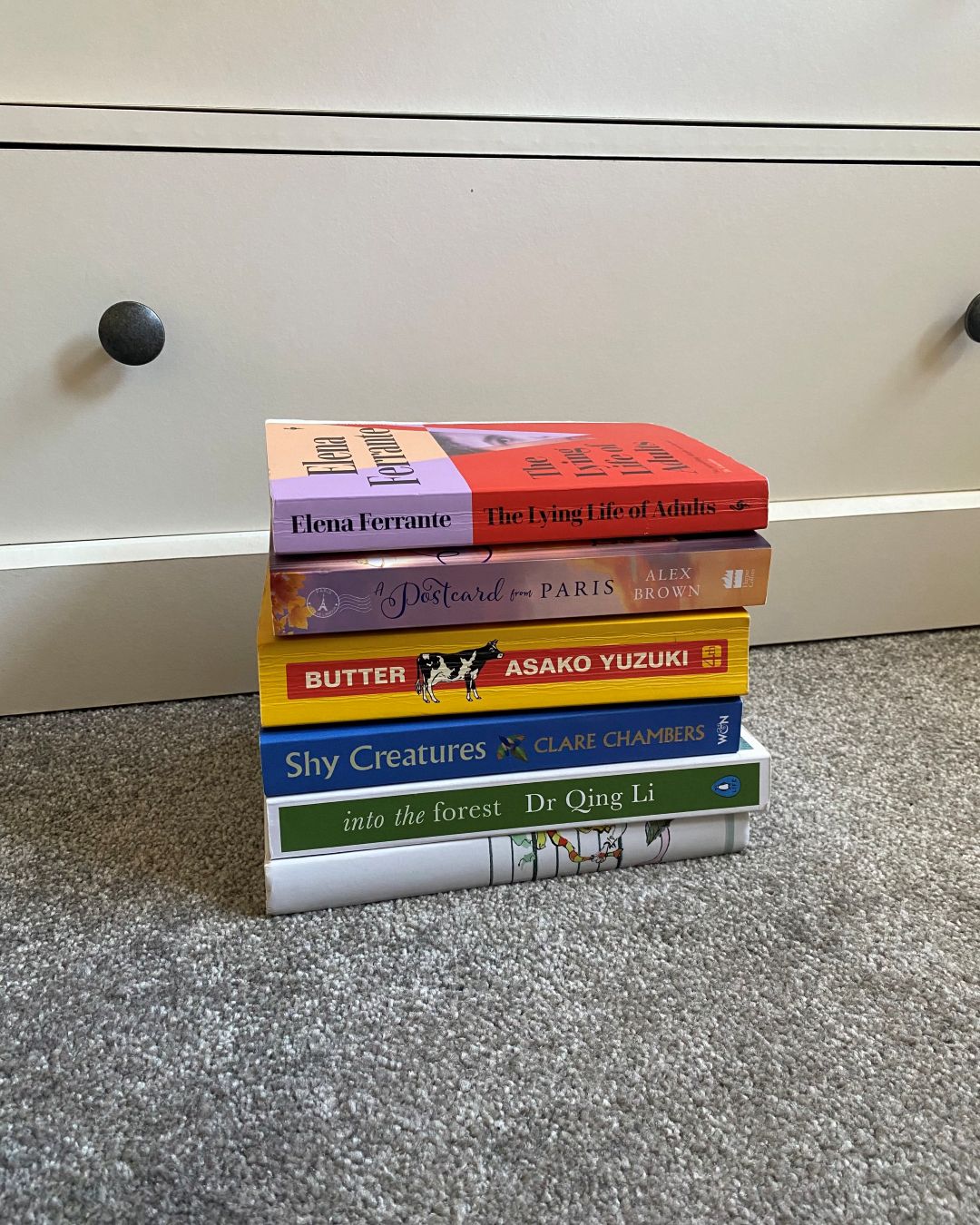stack of books on carpet