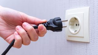 A plug being removed from the wall