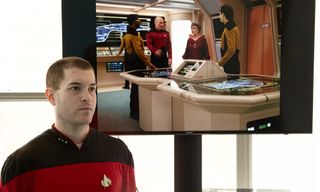 Marshall poses in front of uniformed "Star Trek" characters