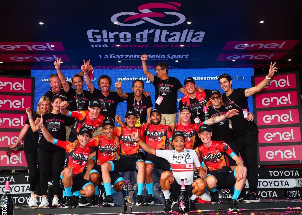 Bahrain Victoriouss team members and staff celebrates winning the best team overall on the podium after the Giro dItalia 2023 cycling race in Rome on May 28 2023 Photo by Luca Bettini AFP Photo by LUCA BETTINIAFP via Getty Images