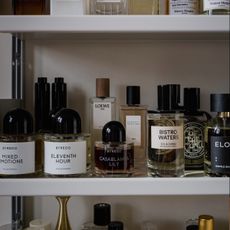 A photo of perfumes bottles on a shelf