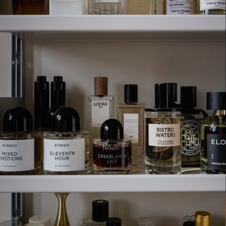 A photo of perfumes bottles on a shelf