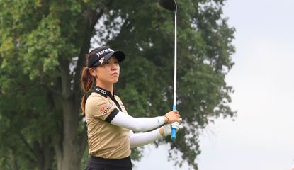 Lydia Ko hits a tee shot and watches the flight