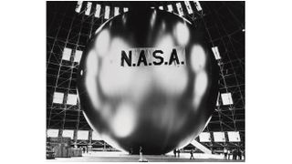 black and white photo of a huge shiny balloon with "nasa" written on it in block letters