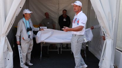 Bryson DeChambeau recovering his ball at the first aid tent at the 2022 WGC-Match Play