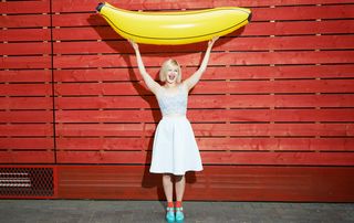 Woman holding an inflatable banana