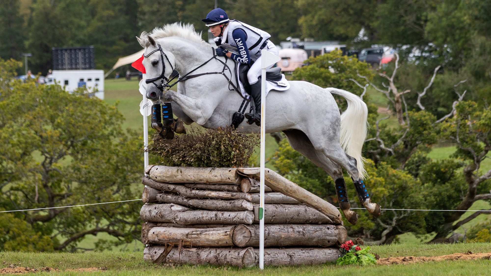 Jemima Howden riding grey horse across country at Cornbury House Horse Trials