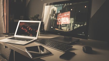 laptop, monitor, phone on desk